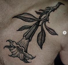 a man's chest with a flower tattoo on it