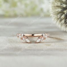 a rose gold ring with two diamonds on it