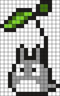 a cross stitch pattern with green and white squares on it, in the shape of a cat