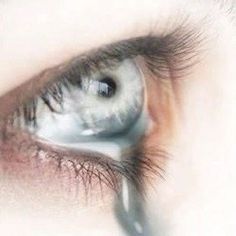 an extreme close up shot of someone's eye with their reflection in the iris