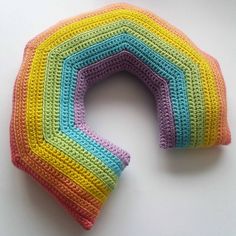 there is a crocheted rainbow shaped object on the table