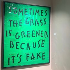 there is a green sign that says sometimes the grass is greener because it's fake