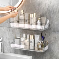 a bathroom shelf filled with different types of skin care products next to a sink and mirror