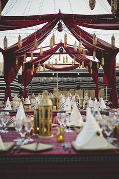 a table is set with white and gold place settings