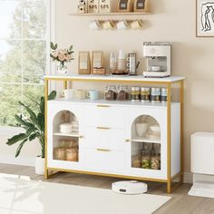 a white and gold sideboard in a living room