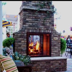 an outdoor fireplace is shown in the middle of a patio