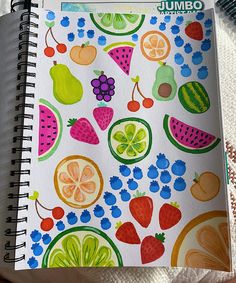 an open spiral notebook with fruit and berries on it