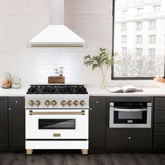 a white stove top oven sitting inside of a kitchen next to a window with an open book on it