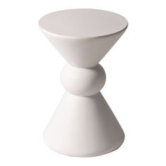 a white vase sitting on top of a table