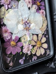 a black tray with flowers in it