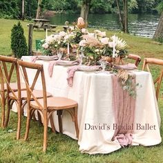 the table is set with flowers and place settings for two people to sit down at