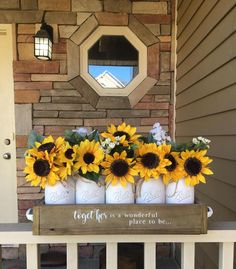 sunflowers are arranged in mason jars on the front porch with a sign that says, today is wonderful