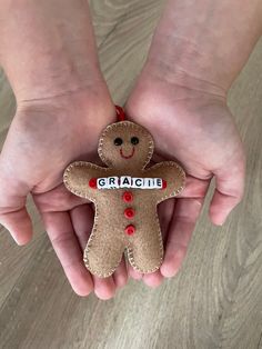 two hands holding a ginger ornament with the word gracie on it