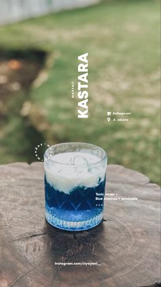 a blue and white drink sitting on top of a wooden table