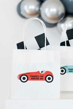 two paper bags with race cars on them