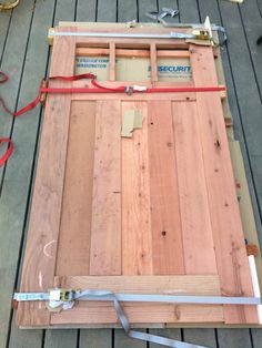 the floor joist is being constructed with wood planks and red tape on it