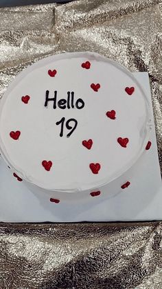 a white cake with red hearts on it