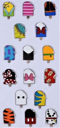 an assortment of pins with different designs on them