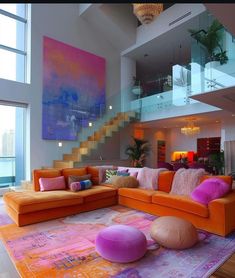 a living room filled with lots of furniture next to a stair case in front of a window