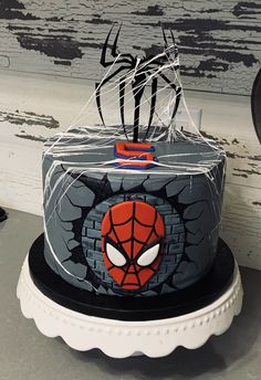 a spiderman cake on a white plate