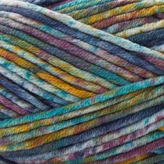 several skeins of multicolored yarn are stacked on top of each other