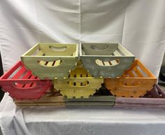 four wooden crates sitting on top of a white table