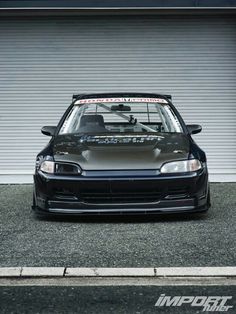 a car parked in front of a garage door