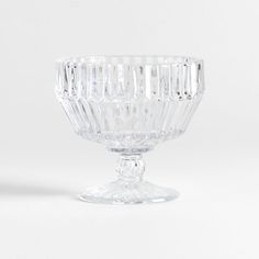 a clear glass bowl sitting on top of a white table