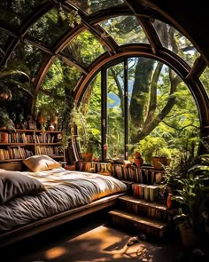 a bed sitting under a large window next to a lush green forest filled with trees