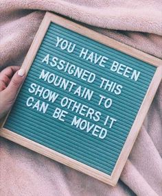 someone holding a sign that says you have been assigned this mountain to show others it can be moved