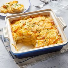 a casserole dish is shown on a table with silverware and utensils