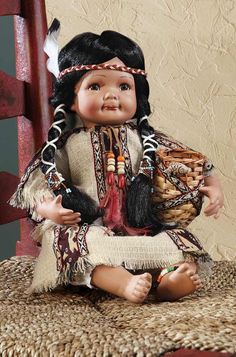 a doll sitting on top of a wooden chair