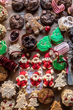 many different types of cookies and pastries are on the table with red, white and green decorations