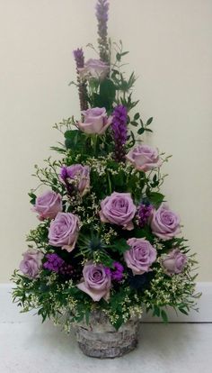 a basket filled with purple flowers on top of a table