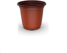 a brown plastic pot sitting on top of a white table next to a green planter