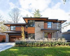 a large modern house with lots of windows and wood trimmings on the front