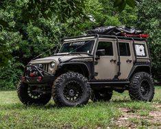 an off road vehicle parked in the grass