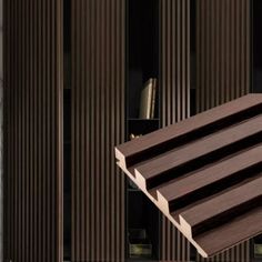 a close up of a wooden structure with vertical slats on the outside and inside