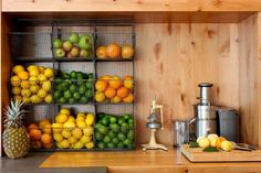 there are many fruits on the shelves in this kitchen