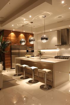 a modern kitchen with stainless steel appliances and lights