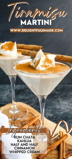 two martinis with cinnamon and whipped cream in them on a wooden tray next to cinnamon sticks