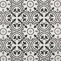 a black and white tile pattern with circular designs on the wall, as well as circles