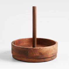 a wooden bowl with a stick sticking out of it's center and two sides