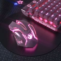 a computer mouse sitting on top of a desk next to a keyboard and mouse pad