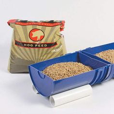 two blue plastic containers filled with sand next to a bag of hog feed on a white background