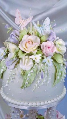 a white cake with flowers and butterflies on it