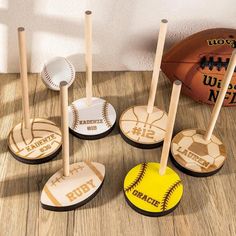 six baseball and softball themed cupcake toppers on a wood floor with a ball in the background