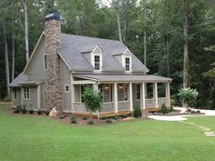 a house in the woods with a stone chimney