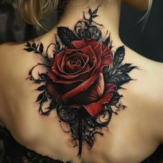 a woman's back tattoo with a rose and leaves on her upper back neck