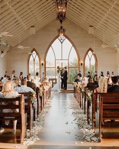 a bride and groom are standing at the alter in front of their wedding ceremony guests